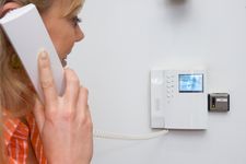 Lady using handset of a door entry system